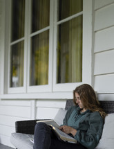 A young woman sitting and reading her Bible