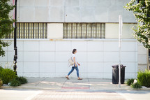 a woman walking on a sidewalk
