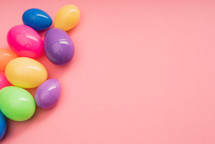 plastic Easter eggs on a pink background 