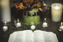 candles and an open Bible