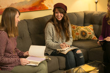 teen girls with Bibles and journals in their laps at a Bible study 