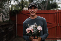 a man holding a bouquet of flowers 
