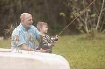 grandfather and grandson fishing together 