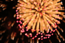 pink and yellow fireworks bursting 