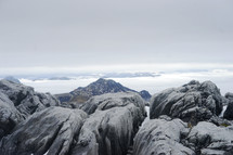 rocks on a mountaintop in the clouds 