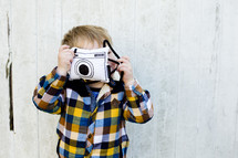 toddler boy with a pretend camera 