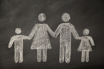 A chalkboard drawing of a family holding hands.