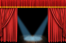 Spotlight on a stage with curtains.