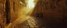 An empty street in the city of Jerusalem in the early morning. Sunlight eliminated the street and lights up the cobble stones. 