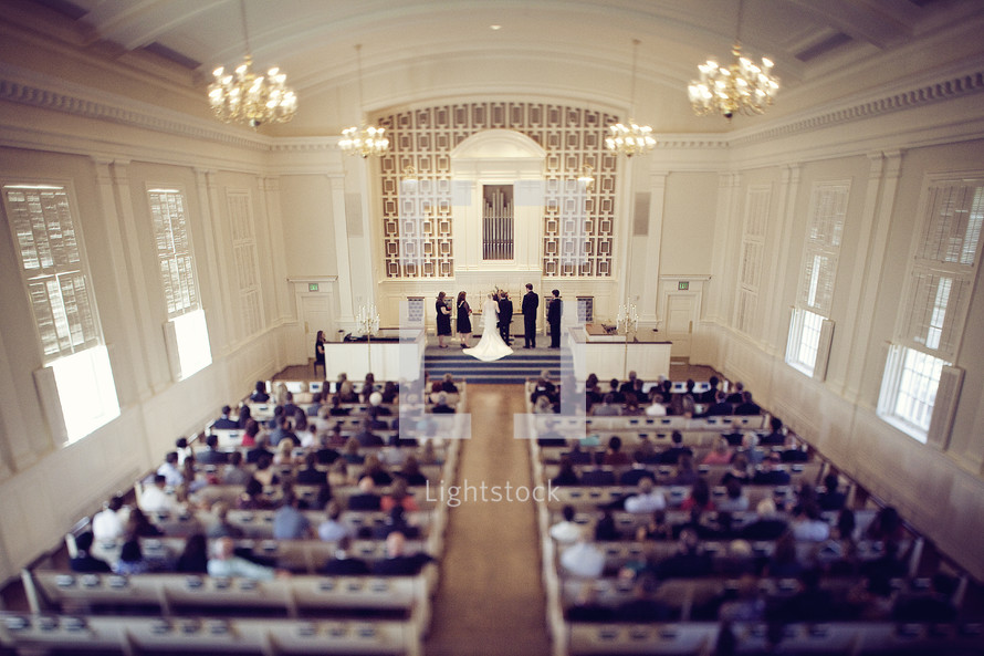 A chapel filled for a wedding ceremony