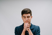 a teen boy praying 
