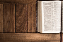 A Bible against wood texture.