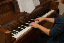 a woman playing a piano 