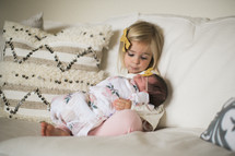 big sister holding a newborn 