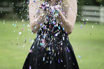 a woman blowing glitter 