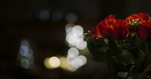 bokeh lights and a bouquet of red roses 