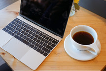 laptop computer and coffee cup