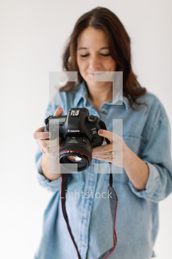 woman checking photo on the back of camera 