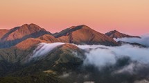 Colors of sunset in mountains above misty clouds in New Zealand nature Time lapse
