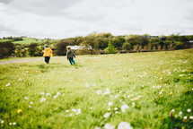 brothers running in a field of grass 