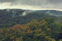 clouds over a fall mountain forest 