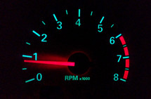 A Speedometer or Odometer on a car to show the Revelations per minute of a car with green lighting on a black background with red and green colors. An odometer or odograph[1][2] is an instrument used for measuring the distance traveled by a vehicle, such as a bicycle or car. The device may be electronic, mechanical, or a combination of the two.