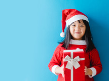 a child holding a Christmas gift 