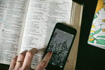 open Bible, journal, and cellphone