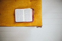 an open Bible on a chair 