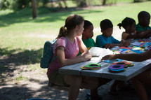 Children doing crafts on a mission trip. 