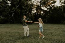 a couple dancing in a field 