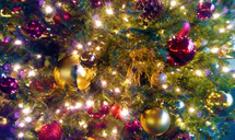 Christmas tree ornaments and lights lighting up a Christmas Tree. 
