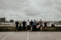 people standing on a parking deck looking over a railing 