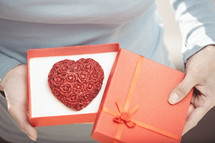 a heart cookie in a red gift box