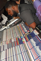 man in a control center at a sound board
