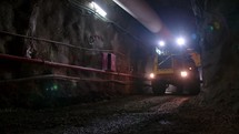 Large construction trucks working inside a tunnel