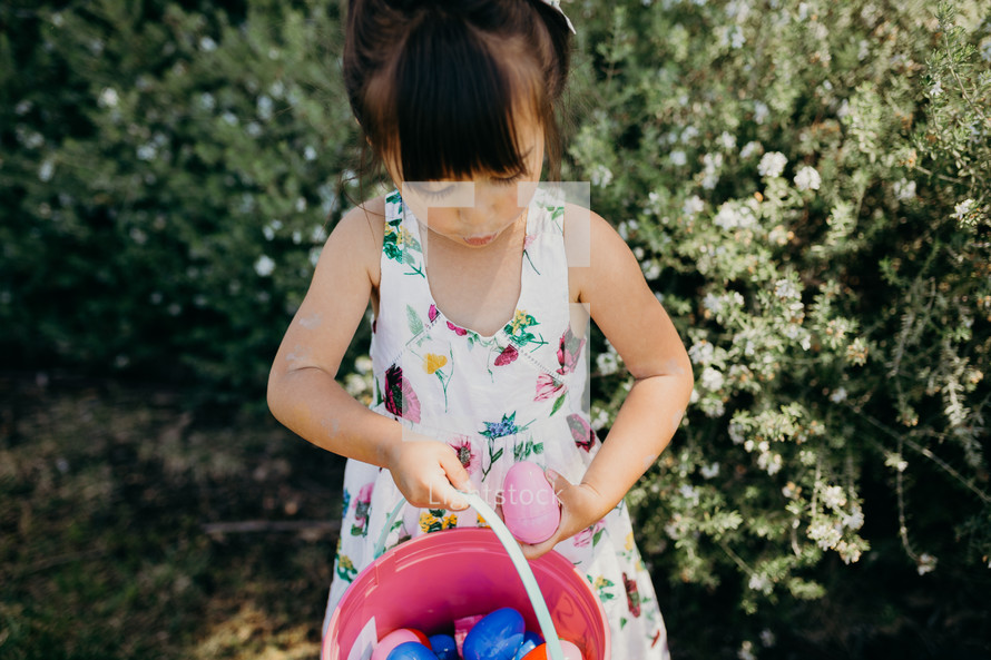 A little girl on an Easter egg hunt 