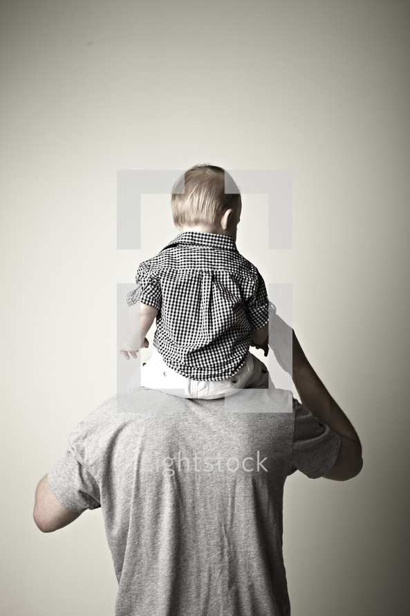A boy sitting on his Dad's shoulders