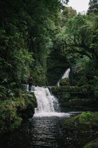 standing near a waterfall in New Zealand 
