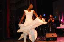 Dancer and singers on stage at a performance