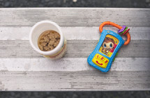 Child's snack and toy on a metal bleacher.