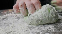 Hands Of A Chef Preparing The Dough For Tagliatelle With Egg And Green Pesto