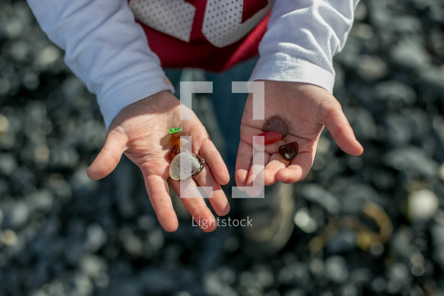 Open hands holding rocks.