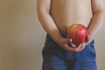 boy child holding a red apple 