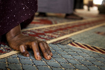 A Ugandan's hand rests on the floor