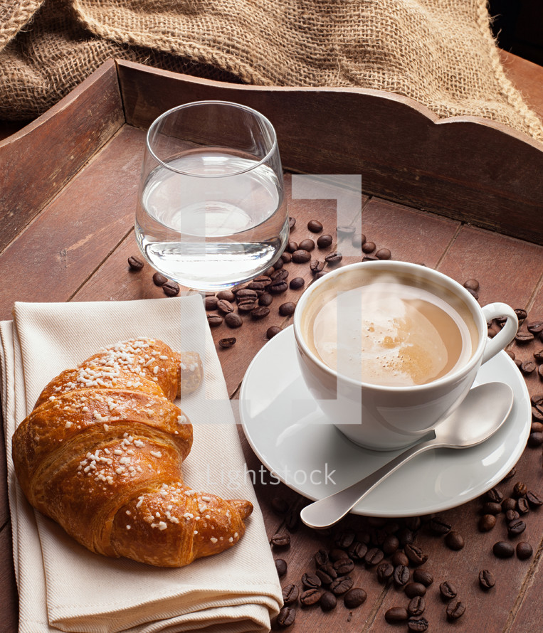 croissant, coffee, and glass of water 