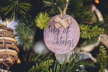 Wooden ornament with the word "king of kings" on a Christmas tree 