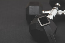 smartwatch, free weights on a black background 