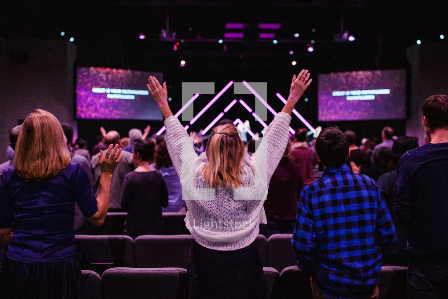 arms raised during a worship service 
