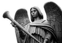 An image of a bronze angel statue holding a trumpet ready to sound a trumpet as mentioned in the book of Revelation. 
